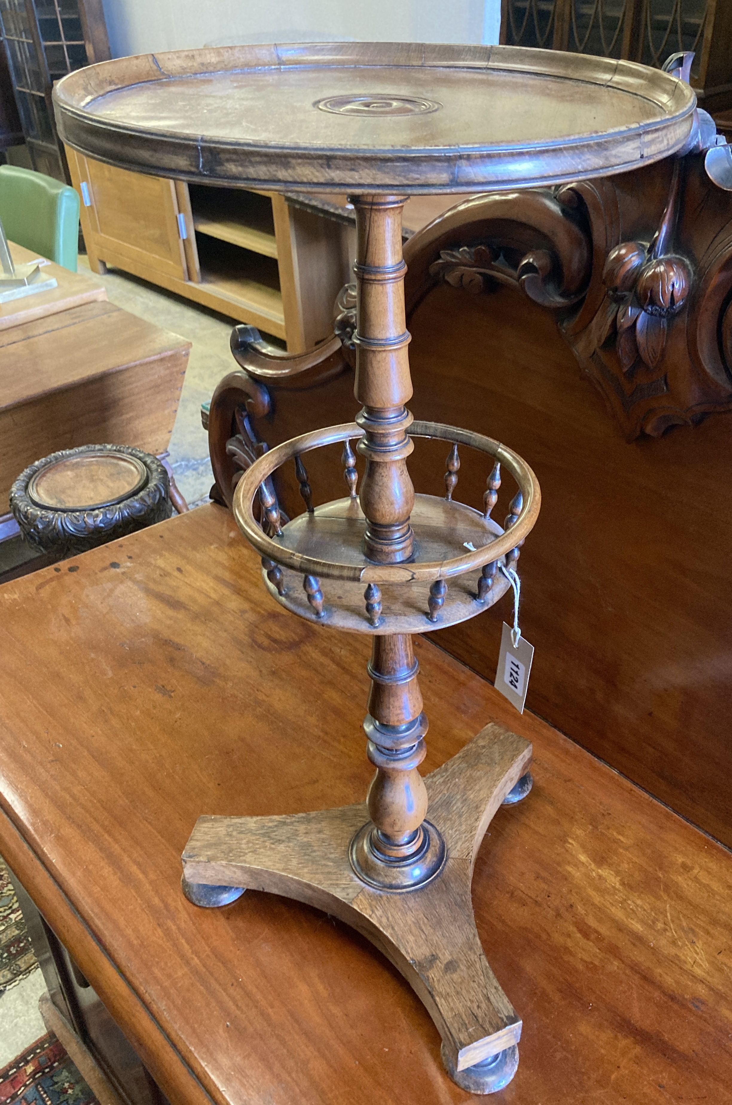 An early Victorian circular rosewood candlestand with galleried shelf on platform base, diameter 35cm, height 72cm